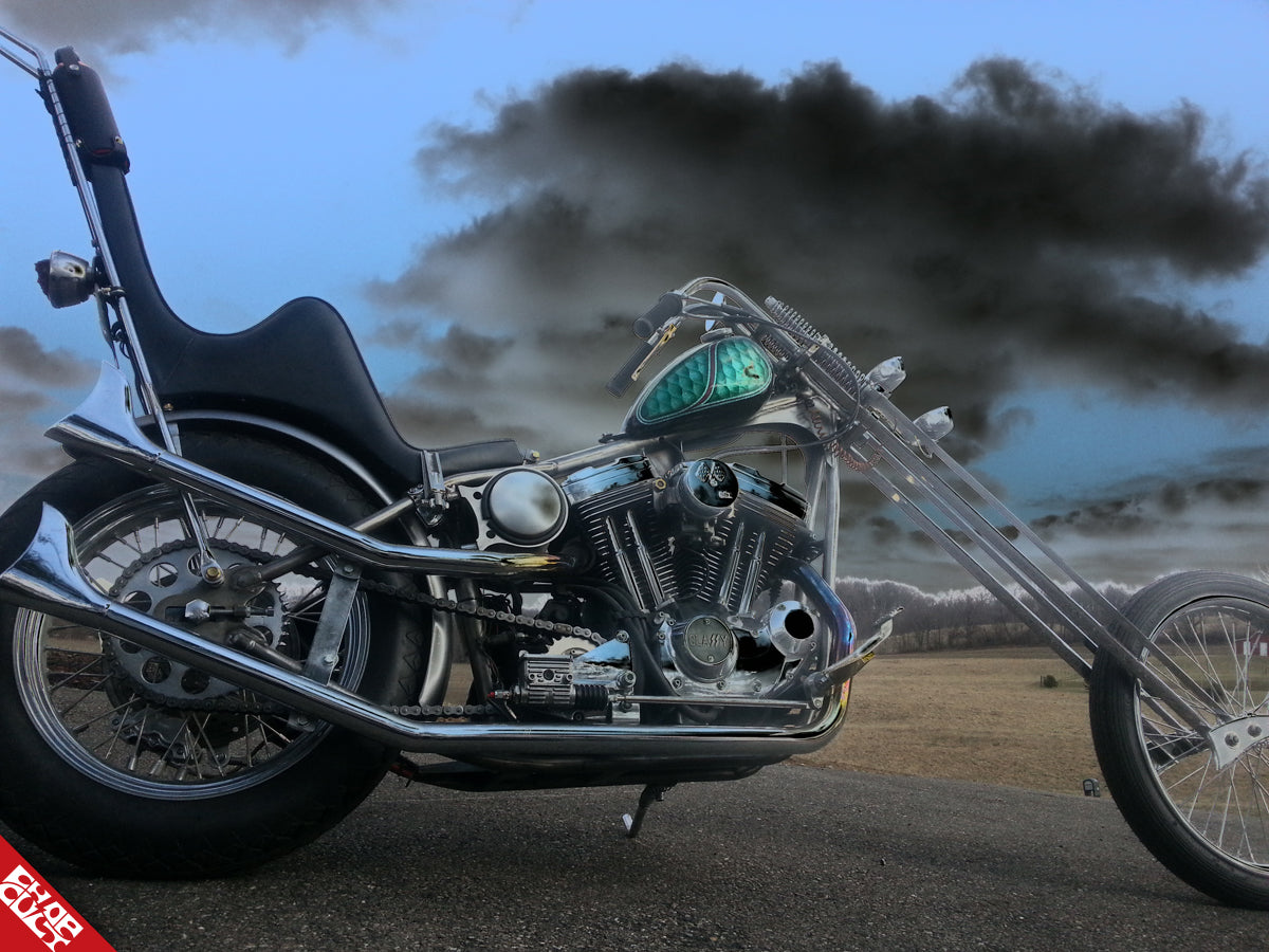 Chrome motorcycle a side with dark cloud overhead