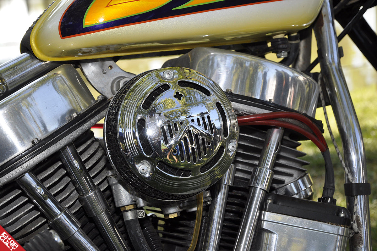 A close up of the bike's motor and oil tank