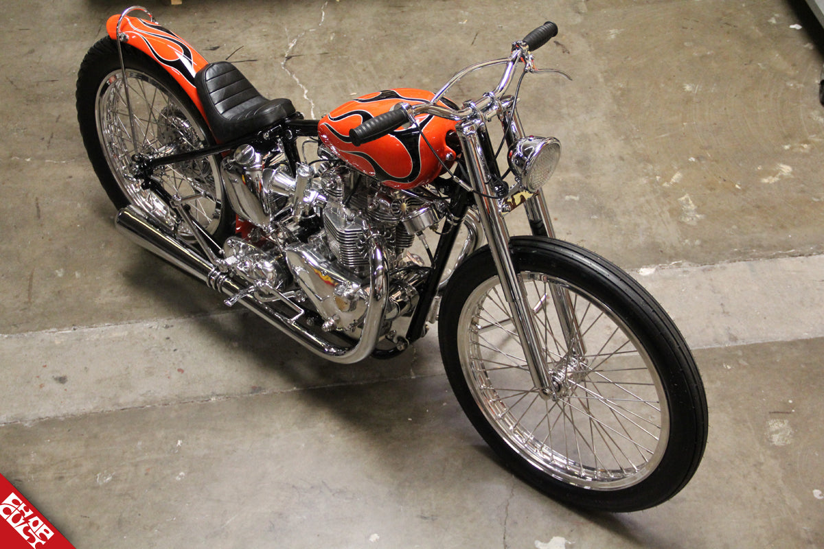 Arial image of the bike showing the narrowed front end of the bike as well as the bike's paint job (orange paint with a black flame pattern)