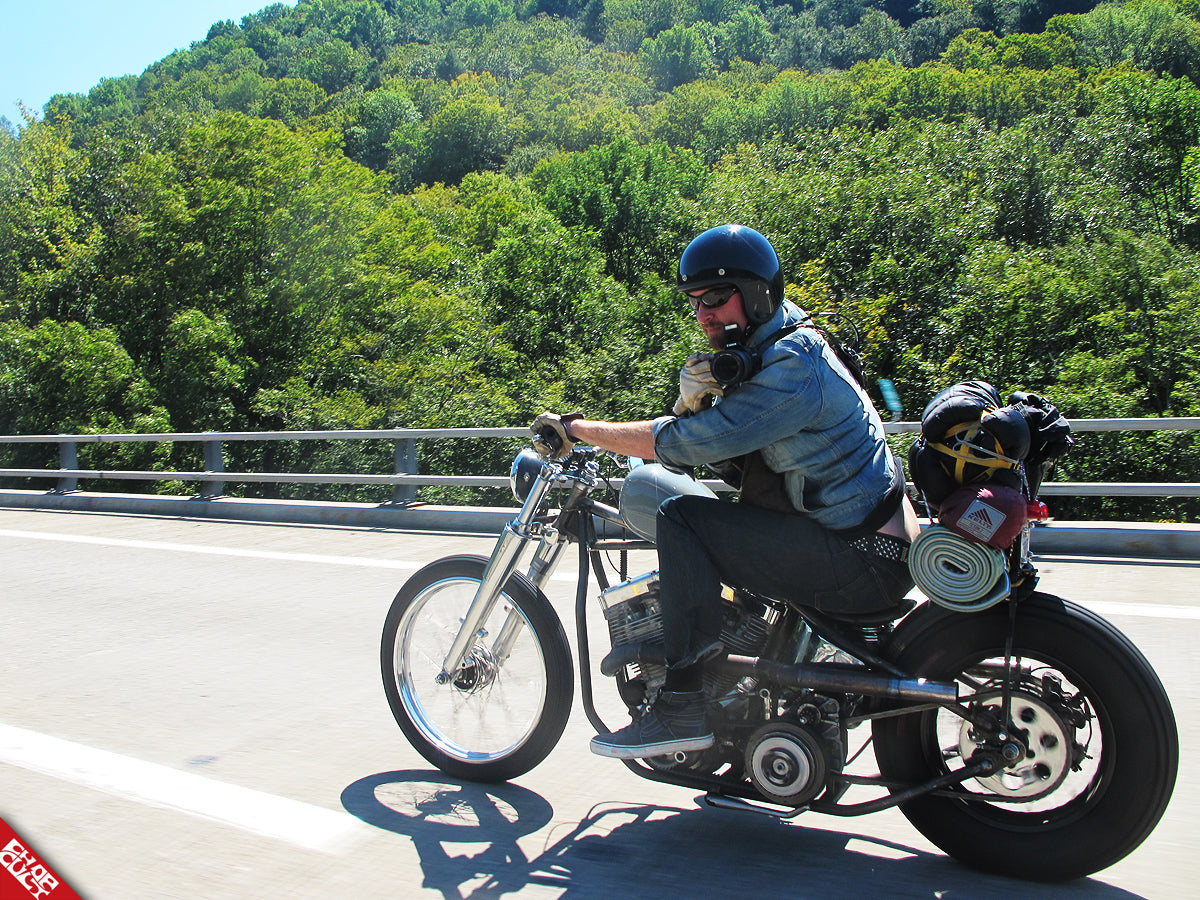 A photo of Malcom riding his bike on the highway